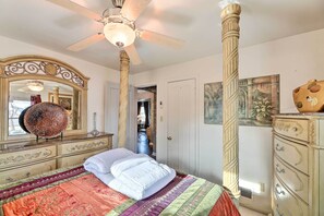 A bedroom with a large bed, ornate dresser, and a ceiling fan. - Pet-friendly Dayton Vacation Rental! (Dayton)