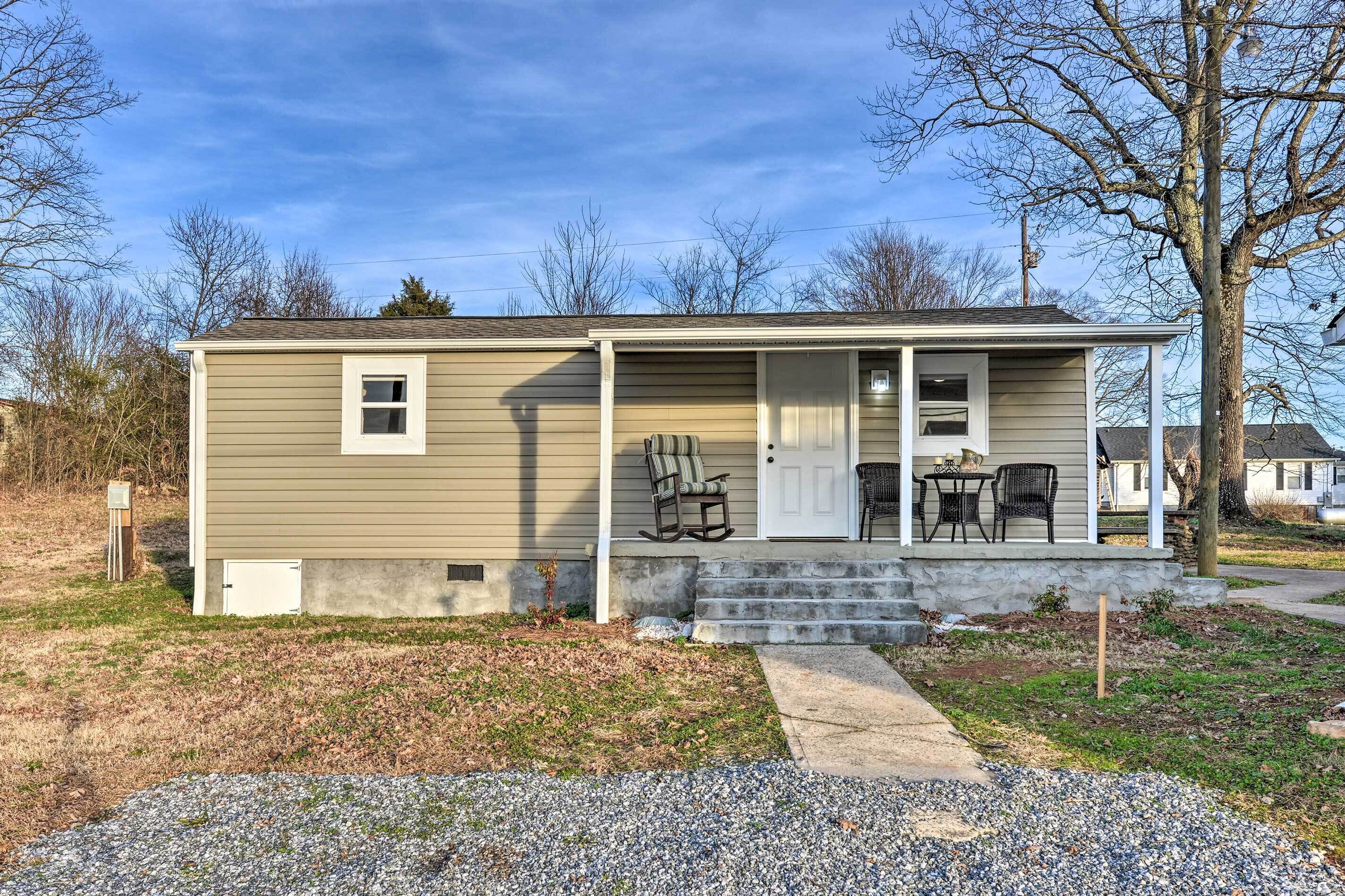 A single-story house with a front porch, a small window, and a door.