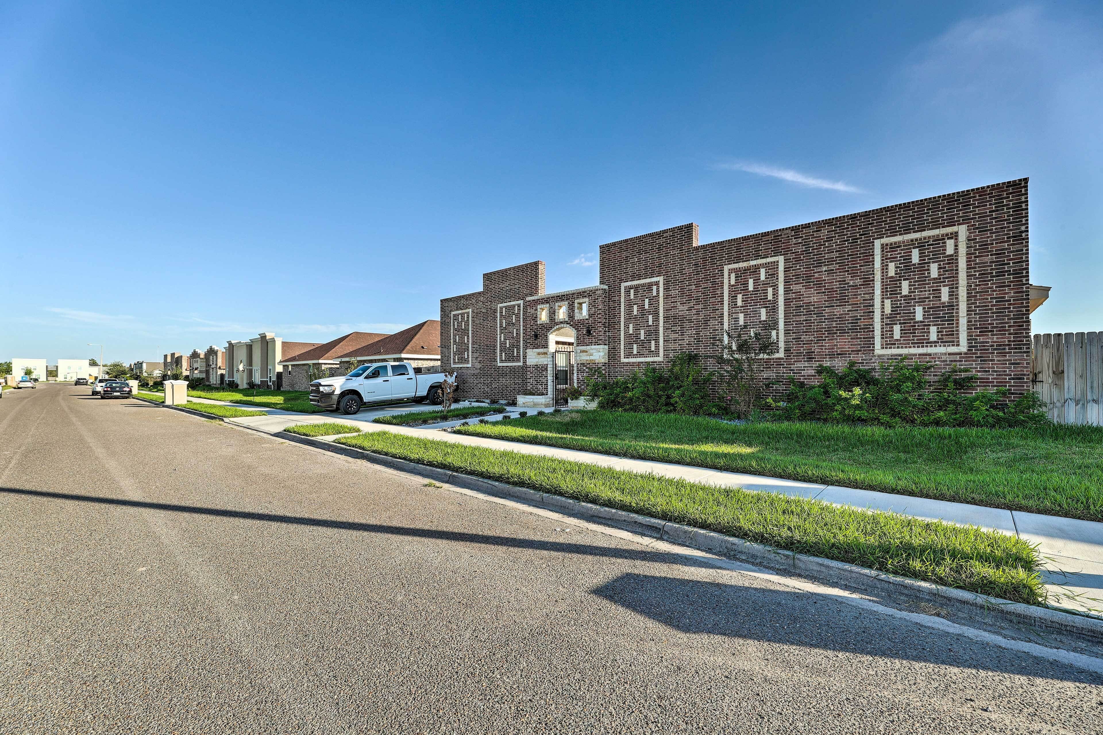 A row of brick buildings with a clear sky.