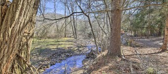 Quaint Creekside Home w/ Spacious Deck & Yard