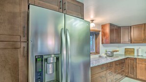 A kitchen with stainless steel appliances, wooden cabinets, a built-in water dispenser, and a granite countertop. - 'moose Park Lodge' Charming Walden Retreat! (Walden)