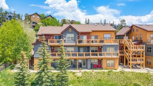 A multi-story building with a wooden exterior, balconies, and a staircase. - Condo Near Winter Park Resort + Steps From Shuttle (Fraser)