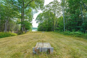An open grassy field with a wooden structure in the foreground and trees in the background. - Peaceful Waterfront Apt w/ Deck, 22 Mi to Portland (Freeport)