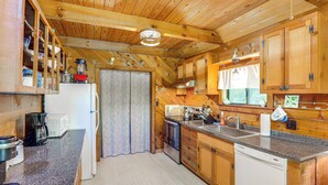 A kitchen with wooden cabinets, a granite countertop, and modern appliances. - Mars Hill Cabin w/ Pool Table ~ 2 Mi to Wolf Ridge (Mars Hill)