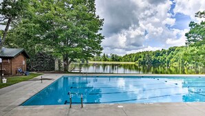 A rectangular swimming pool with clear blue water, surrounded by a concrete deck. - In Golf Community w/ Pool Access: Newland Cabin (Newland)