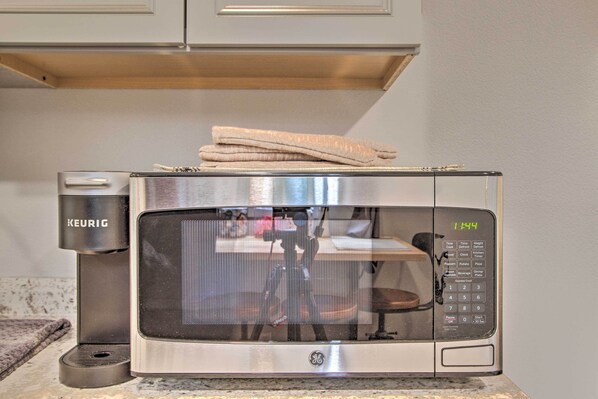 A GE microwave with a KEURIG coffee maker on a kitchen counter. - Steps to Foothills Trail: Unique Carbonado Studio (Carbonado)