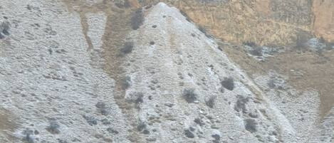 A rugged mountain landscape with rocky terrain and sparse vegetation.
