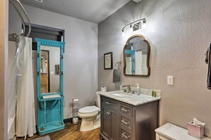 A bathroom with a toilet, sink, and mirror. - Piedmont Rally Stay: 10 Acres w/ Hot Tub & Parking (Piedmont)