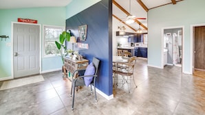 A spacious living area with a dining table and chairs, a kitchen in the background, and a ceiling fan. - Dock & Lake Access: Tranquil Home in Hot Springs (Hot Springs)