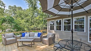 A wooden deck with wicker furniture, including sofas and a round table with chairs. - Dock & Lake Access: Tranquil Home in Hot Springs (Hot Springs)