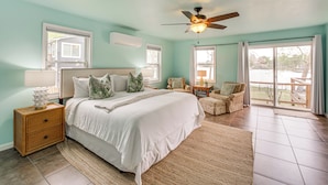 A bedroom with a bed, nightstand, and a ceiling fan. - Dock & Lake Access: Tranquil Home in Hot Springs (Hot Springs)