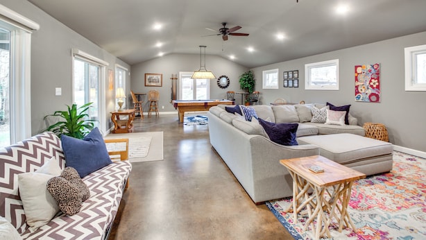 A spacious living room with a gray sofa, a wooden coffee table, and a colorful rug. - Dock & Lake Access: Tranquil Home in Hot Springs (Hot Springs)