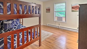 A room with a bunk bed, a radiator, a window with blinds, and a door. - 7 Mi to Lake Harmony: Home w/ Furnished Deck! (Albrightsville)