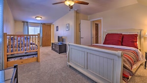 A bedroom with a white bed, red pillows, a ceiling fan, and a small dresser. - Downtown Cedar City House < 1/2 Mi to SUU Campus! (Cedar City)