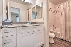 A bathroom with a sink, mirror, toilet, and shower. - Family-friendly Oceanside Home: 5 Mi to Beach (Oceanside)