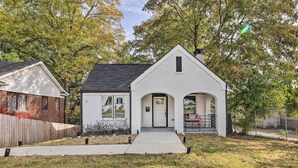 A single-story house with a white exterior, a black roof, and a front porch with two columns. - Eclectic Atlanta Abode < 3 Mi to Downtown! (Atlanta)