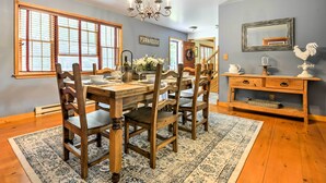 A dining area with a wooden table and chairs, a chandelier, and a rustic decor. - Thompson Home w/ Deck + Pond, 8 Mi to Elk Mountain (Thompson)