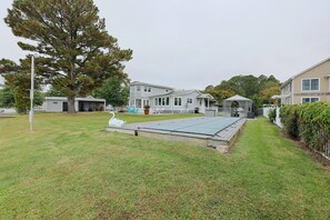 A residential area with a large lawn, a gazebo, and a swimming pool. - Grasonville Home w/ Private Pool on the Water (Grasonville)
