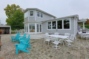 A two-story house with a covered patio area.