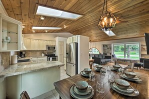 A spacious kitchen with wooden ceiling, a large island, and modern appliances. - Lake Nagawicka Home - 2 Blocks to Boat Launch (Delafield)