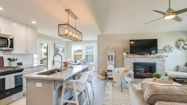 A modern kitchen with white cabinets, a built-in microwave, and a central island with bar stools. - Pet-friendly Retreat w/ Fenced Yard, Walk to Beach (Ocean Shores)
