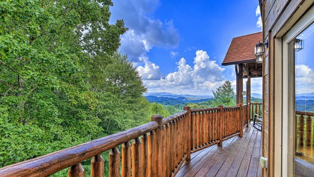 A wooden deck with a railing overlooking a forested landscape. - River Access & Game Room: Piney Creek Cabin! (Piney Creek)