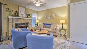 A living room with a fireplace, two blue armchairs, a beige sofa, and a ceiling fan. - Mountain Retreat Near Jack Frost & Big Boulder (White Haven)