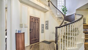 A grand staircase with white balusters and a dark handrail, leading to an upper level. - Han Solo's Hideout Luxe Houston Home w/ Pool! (Houston)