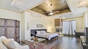 A modern bedroom with a bed, bedside table, and a ceiling fan. - Han Solo's Hideout Luxe Houston Home w/ Pool! (Houston)