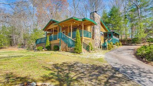 A lodge with a porch, a stone chimney, and a wooden deck. - Murphy Cabin w/ Deck, Grill & Private Pond! (Murphy)