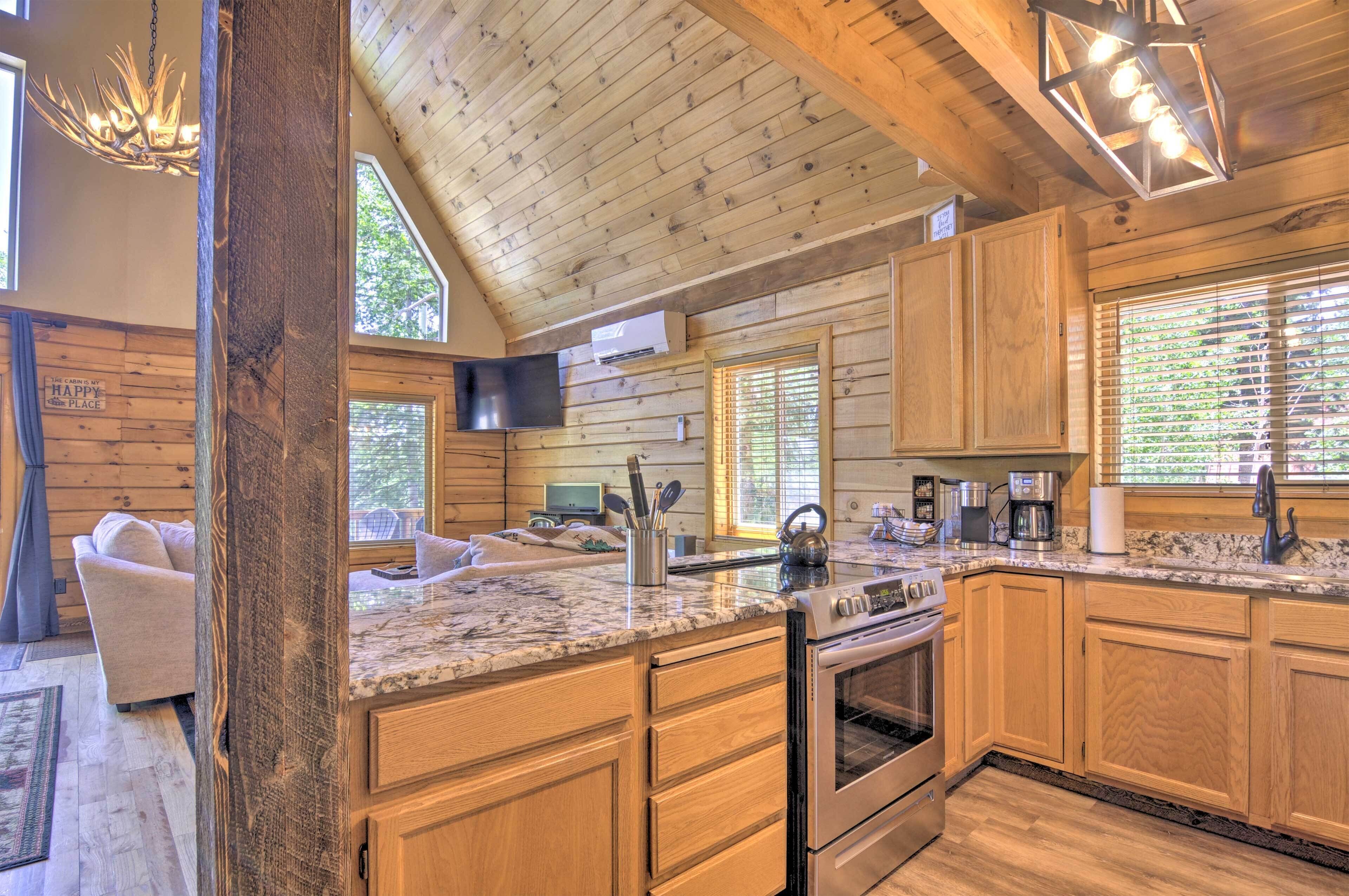 A log cabin kitchen with wooden cabinets, a granite countertop, and a built-in oven.