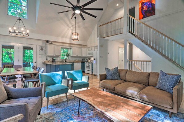 A spacious living area with a high ceiling, a dining table, and a sofa. - 2 Mi to Sapphire Resort: Home w/ Hot Tub & Games! (Sapphire)