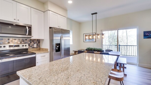 A modern kitchen with granite countertops, stainless steel appliances, and a large island. - Mtn Retreat w/ EV Charger Near Bryce Ski & Golf (Mount Jackson)