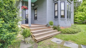 A house with a porch, steps leading to the entrance, and a small garden area with potted plants. - Walk to Downtown: Pet-friendly Millerton Home! (Millerton)