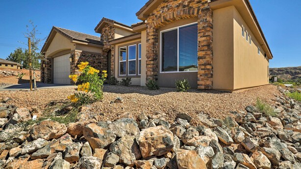 A modern house with a stone facade, large windows, and a well-maintained garden. - La Verkin Home w/ Hot Tub, Kayaks, & Bikes! (La Verkin)