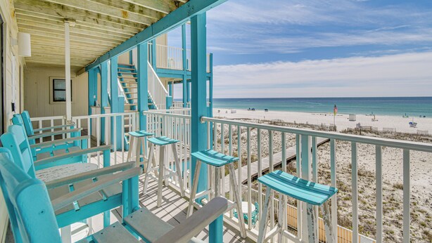 A beachside wooden deck with blue benches and a staircase leading to a balcony overlooking the beach. - Oceanfront Gulf Shores Condo ~ 2 Mi to The Hangout (Gulf Shores)