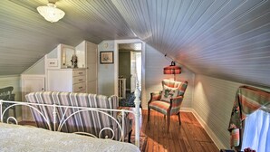 A bedroom with a bed, two chairs, a dresser, and a small table. - Walk to Main St Action! Spacious Historic Retreat (Fredericksburg)