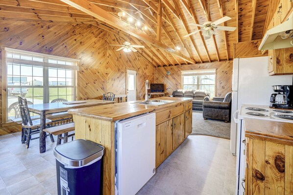 A spacious kitchen with wooden cabinets, a dishwasher, and a stove. - Racine Vacation Rental 25 Mi to Athens! (Racine)