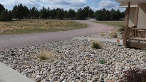 A gravel driveway leading to a building with a covered porch.