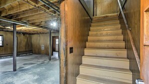 A wooden interior with a staircase leading to a door.