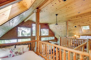 A wooden cabin with a loft bedroom, a balcony, and a staircase. - Thunder Lake Escape + Boat Dock! (Remer)