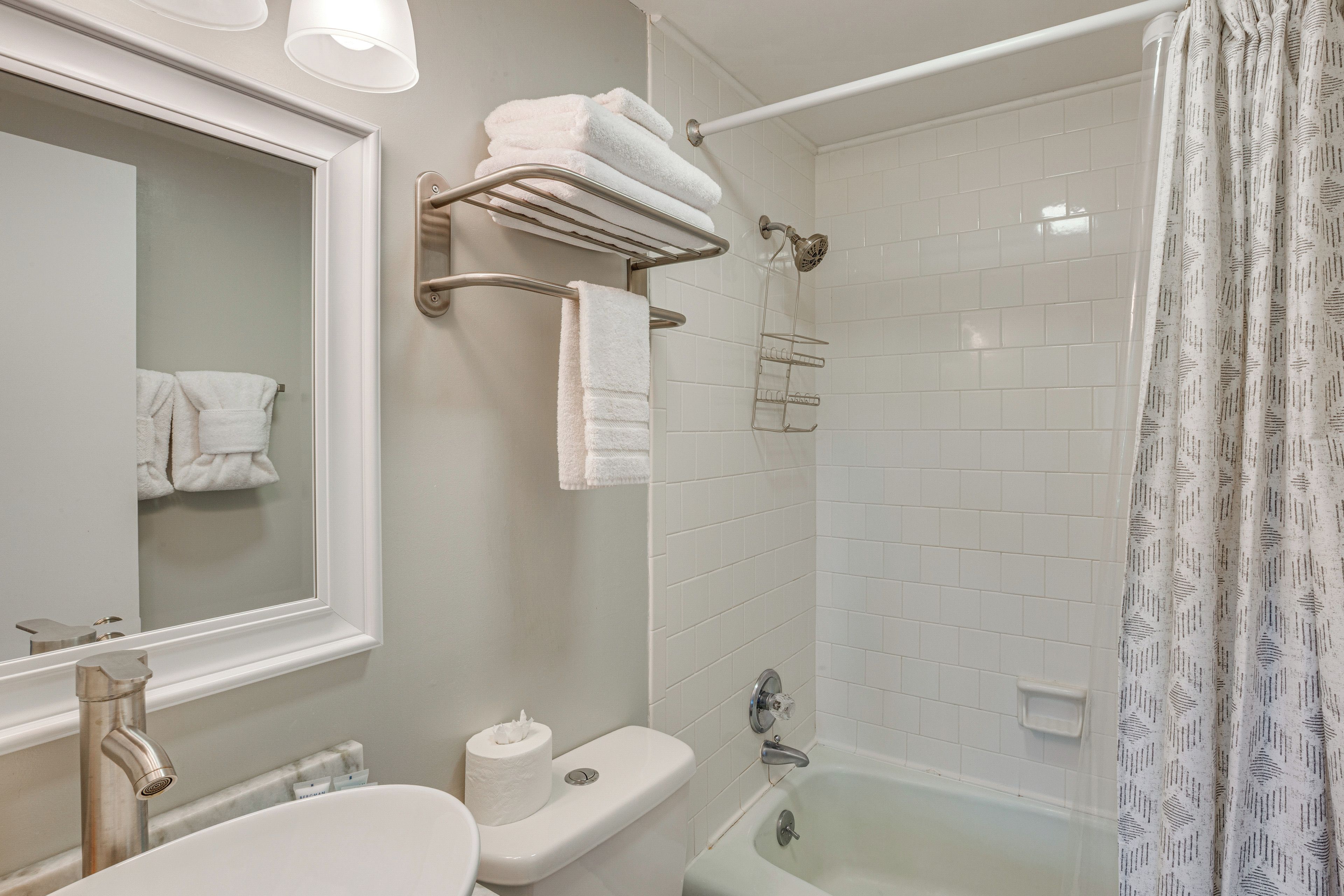A bathroom with a toilet, sink, and shower.