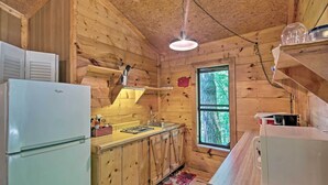 A wooden cabin kitchen with a refrigerator, sink, and wooden cabinets. - Pisgah Forest 'the Oak' Cabin w/ Deck by Creek (Barnardsville)