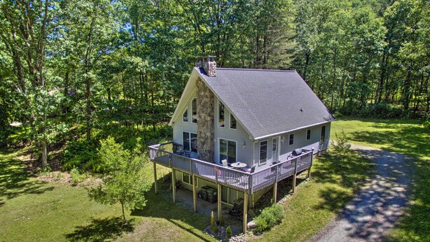 A two-story house with a balcony, surrounded by a wooded area. - Spacious Home w/ Deck, Grill & Delaware River View (Callicoon)