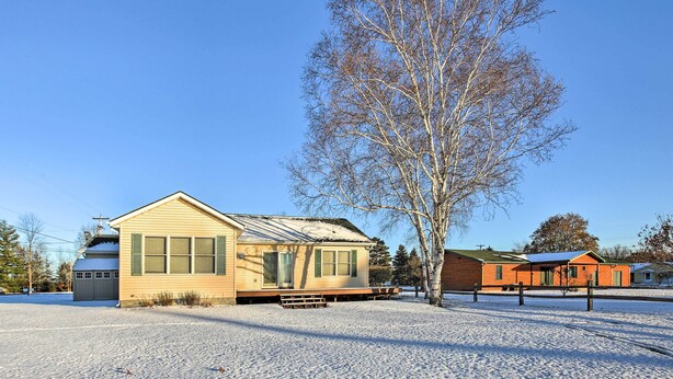 A single-story house with a sloped roof, a front porch, and a small attached garage.