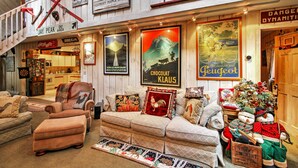 A cozy, rustic interior with a sofa, ottoman, and a Christmas tree. - West Dover Vacation Rental w/ Hot Tub Near Mt Snow (West Dover)