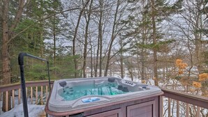 A hot tub on a wooden deck with a view of trees and a snowy landscape. - West Dover Vacation Rental w/ Hot Tub Near Mt Snow (West Dover)