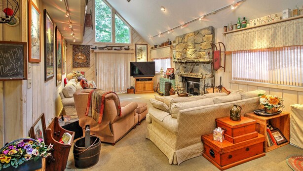 A cozy living room with a fireplace, comfortable seating, and a television. - West Dover Vacation Rental w/ Hot Tub Near Mt Snow (West Dover)