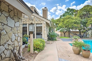 A stone building with a pool, outdoor seating, and a clear sky. - Horseshoe Bay Resort Townhome - Near Lake Lbj! (Horseshoe Bay)