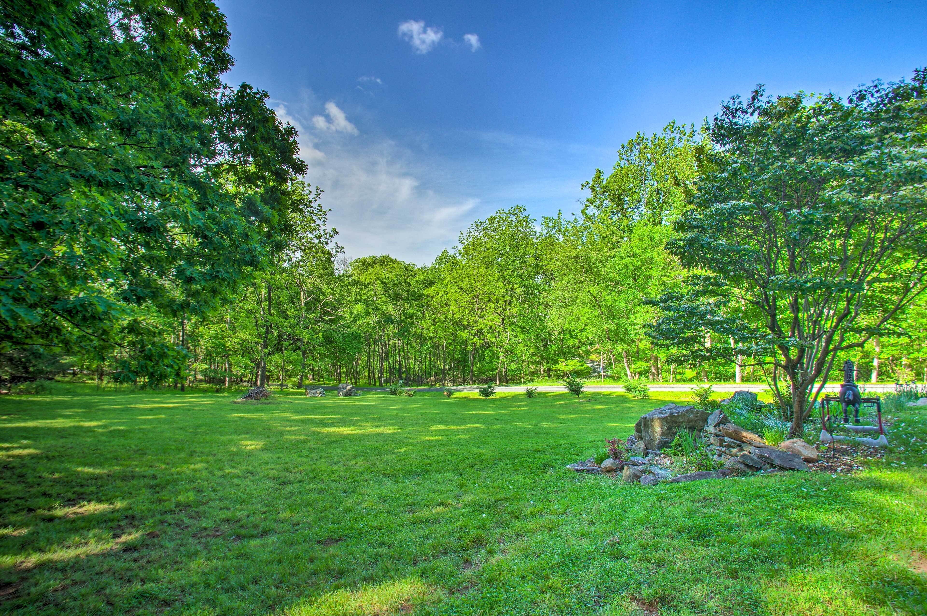 A park with a grassy area, trees, and a playground.